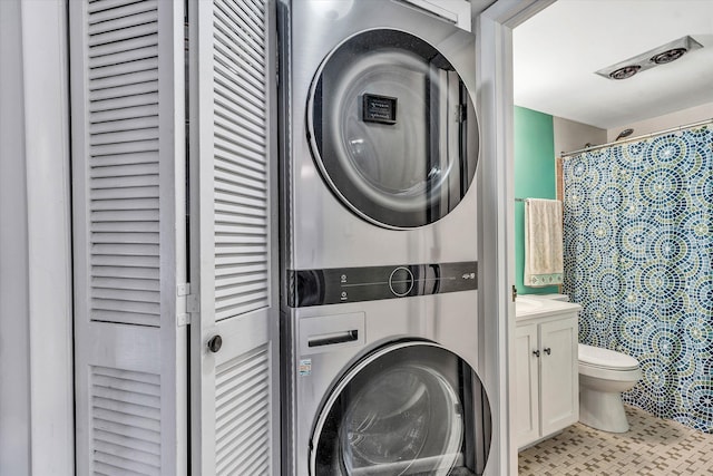 laundry area with stacked washer and clothes dryer and laundry area