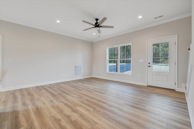 unfurnished room featuring light wood-style floors, visible vents, ornamental molding, and ceiling fan