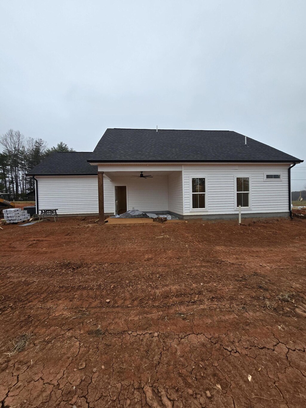 back of house with roof with shingles