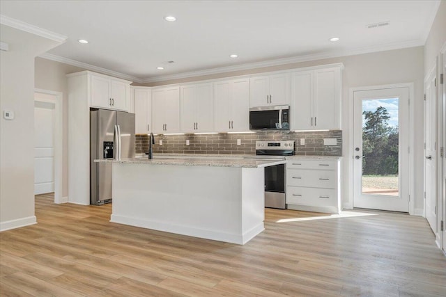 kitchen featuring white cabinets, visible vents, backsplash, and appliances with stainless steel finishes