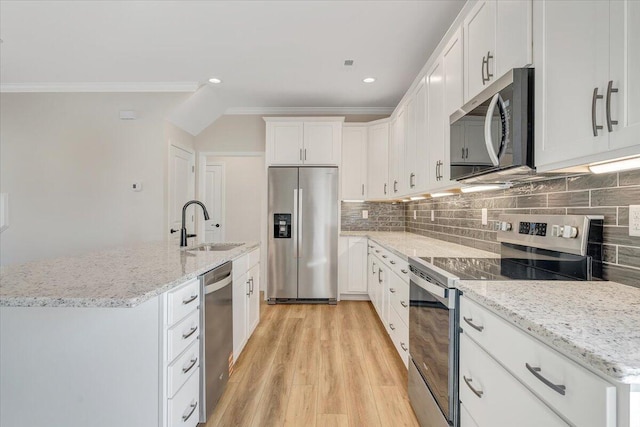 kitchen featuring light wood-type flooring, white cabinetry, crown molding, stainless steel appliances, and a sink