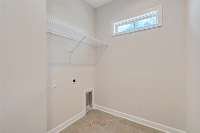 laundry room with laundry area, hookup for an electric dryer, and baseboards
