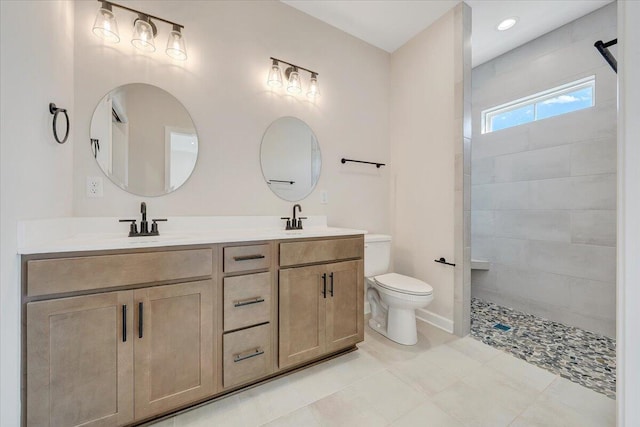 bathroom featuring a sink, toilet, a walk in shower, and double vanity