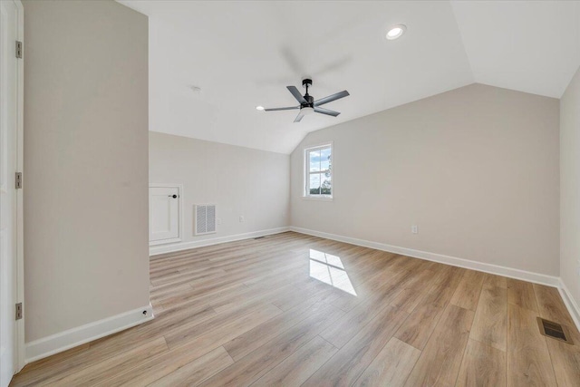 additional living space featuring visible vents, baseboards, a ceiling fan, and vaulted ceiling