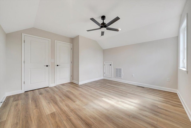 bonus room featuring visible vents, light wood-type flooring, a ceiling fan, and lofted ceiling