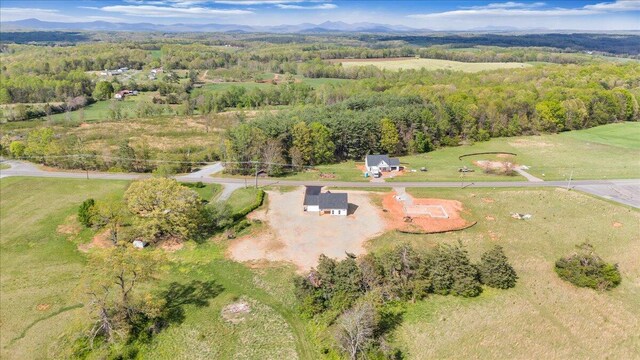 birds eye view of property with a view of trees and a mountain view