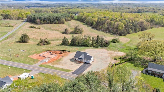 birds eye view of property with a forest view