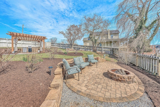 view of patio / terrace with an outdoor fire pit, a pergola, and a fenced backyard