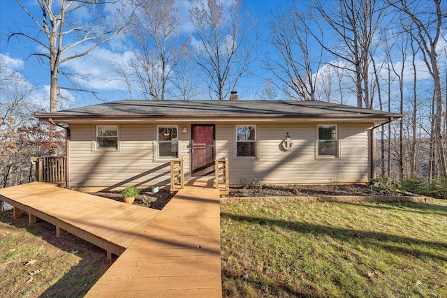 view of front of home featuring a chimney and a front yard