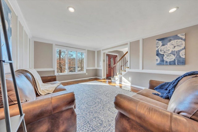 living area with baseboards, stairs, ornamental molding, recessed lighting, and wood finished floors