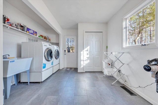 laundry room featuring washer and dryer and visible vents