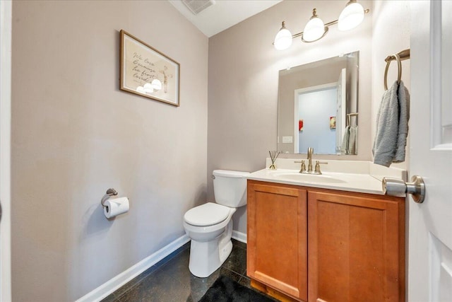 bathroom featuring vanity, baseboards, visible vents, tile patterned floors, and toilet