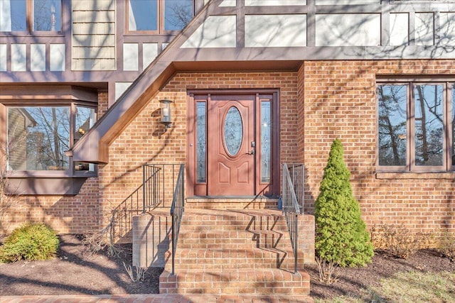 doorway to property featuring brick siding