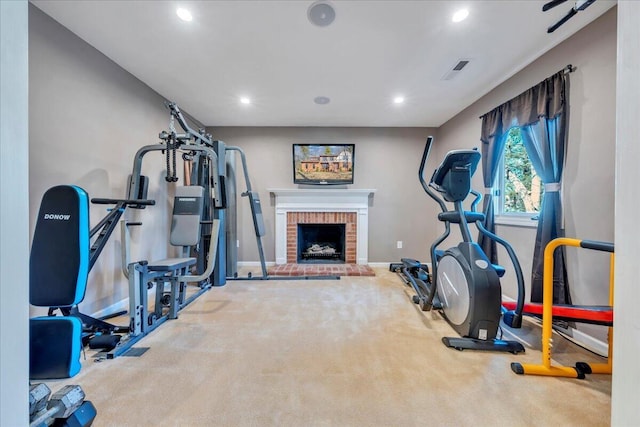 workout area featuring a brick fireplace, carpet flooring, recessed lighting, and baseboards