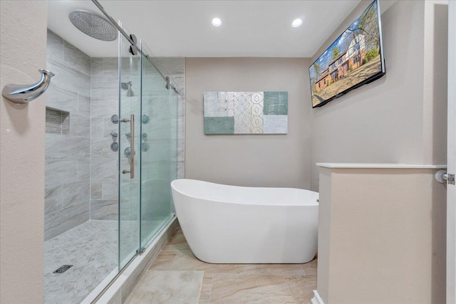 bathroom featuring a freestanding tub, recessed lighting, and a stall shower