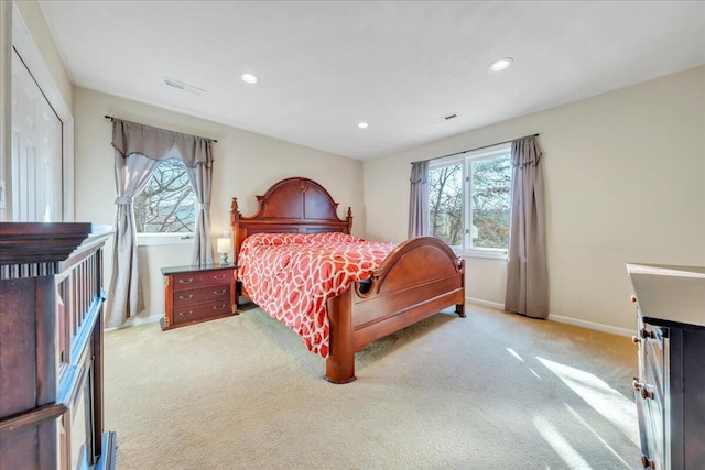 bedroom featuring recessed lighting, light colored carpet, visible vents, and baseboards