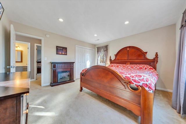 bedroom featuring baseboards, a fireplace, recessed lighting, a closet, and light colored carpet