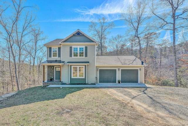 view of front facade with a garage, driveway, and a front lawn