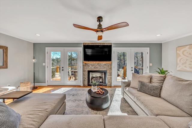 living area featuring ornamental molding, french doors, wood finished floors, and a healthy amount of sunlight