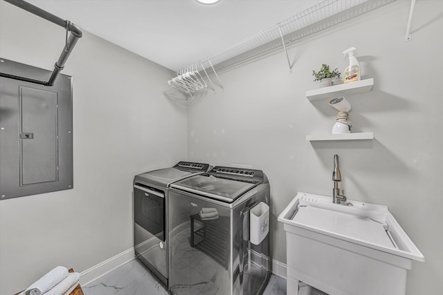 washroom featuring laundry area, electric panel, baseboards, washing machine and clothes dryer, and marble finish floor