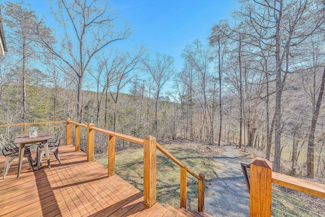 wooden deck featuring a forest view