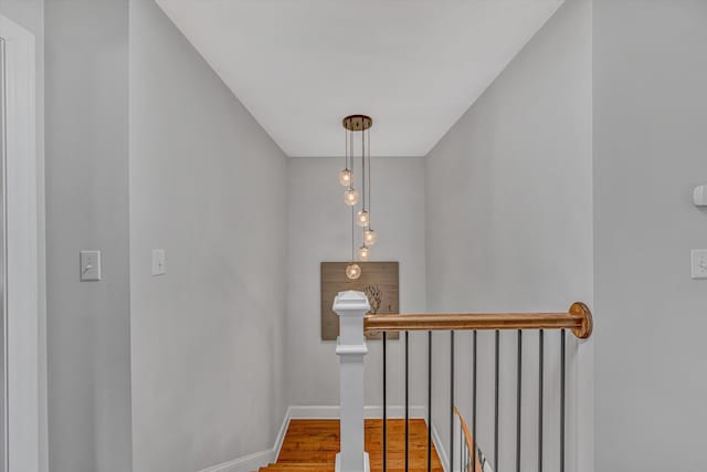 stairway with baseboards and wood finished floors