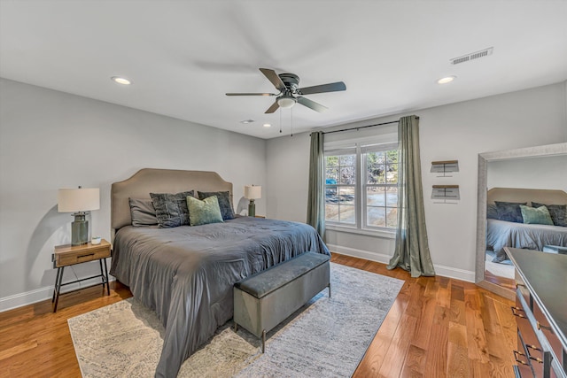 bedroom with light wood-type flooring, baseboards, visible vents, and recessed lighting