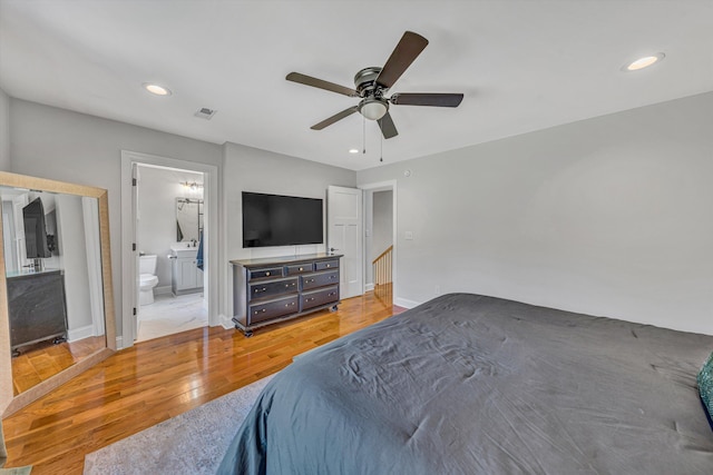 bedroom featuring recessed lighting, a ceiling fan, baseboards, light wood-type flooring, and ensuite bath