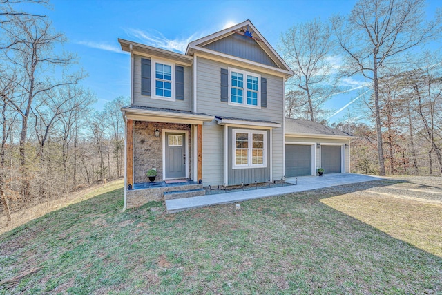 traditional home with a garage, concrete driveway, stone siding, and a front yard