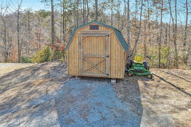 view of shed with a view of trees