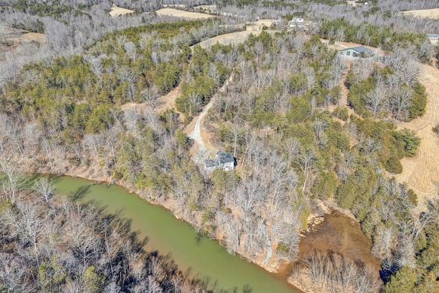 drone / aerial view with a water view and a forest view