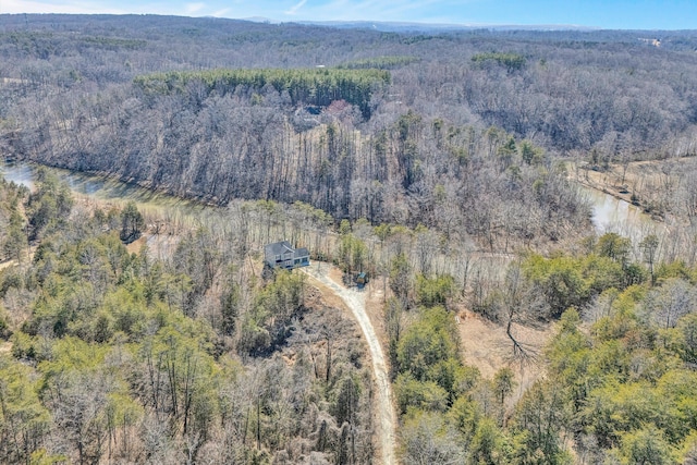 drone / aerial view with a water view and a wooded view