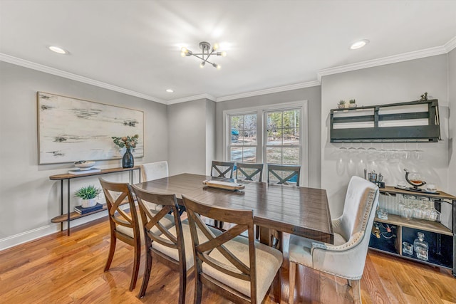 dining area with baseboards, light wood-style flooring, ornamental molding, a chandelier, and recessed lighting