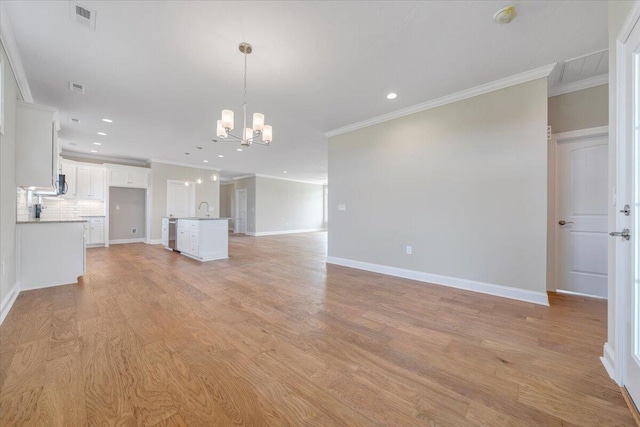 unfurnished living room featuring recessed lighting, a notable chandelier, and crown molding