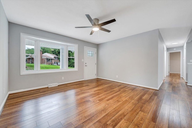 4438 Stonewall Rd NW, Roanoke, VA 24017 - spare room featuring wood-type flooring, ceiling fan, and baseboards