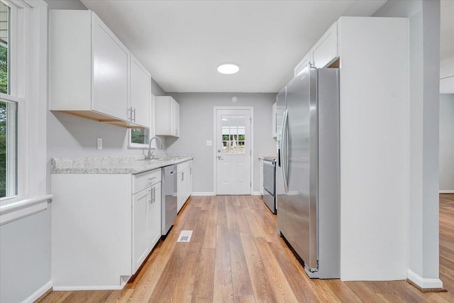 4438 Stonewall Rd NW, Roanoke, VA 24017 - kitchen with appliances with stainless steel finishes, a sink, baseboards, and light wood finished floors