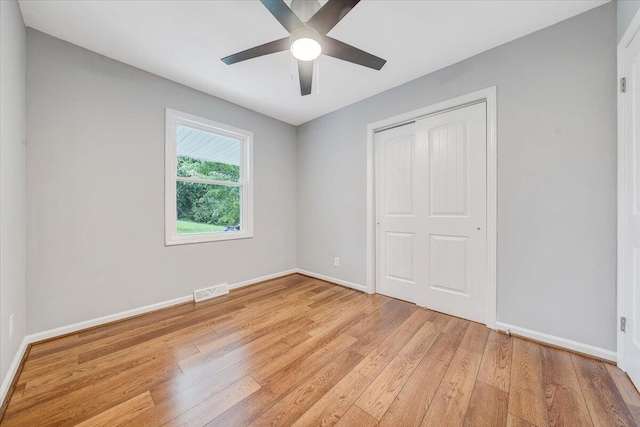 4438 Stonewall Rd NW, Roanoke, VA 24017 - unfurnished bedroom with light wood-type flooring, baseboards, a closet, and a ceiling fan