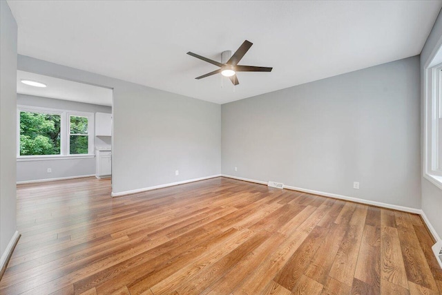 4438 Stonewall Rd NW, Roanoke, VA 24017 - spare room featuring light wood-type flooring, a ceiling fan, and baseboards