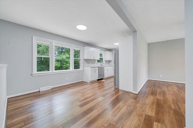 4438 Stonewall Rd NW, Roanoke, VA 24017 - unfurnished living room with light wood-style floors, baseboards, and a sink
