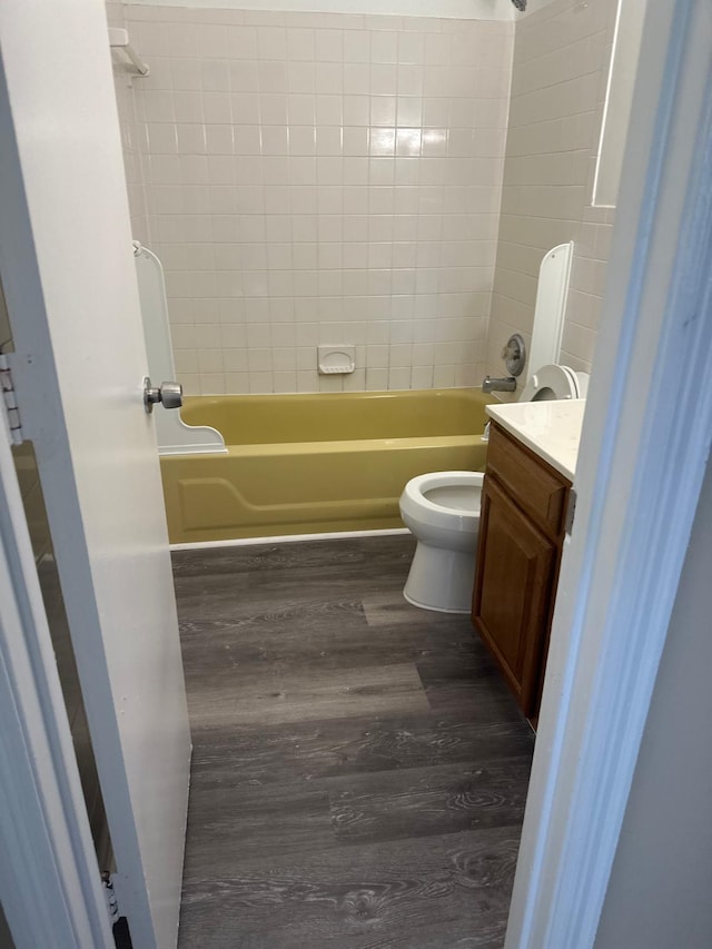 bathroom featuring shower / tub combination, vanity, toilet, and wood finished floors