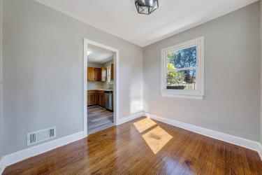 unfurnished dining area featuring baseboards and wood finished floors