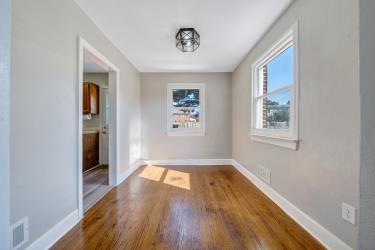 unfurnished dining area featuring baseboards and wood finished floors