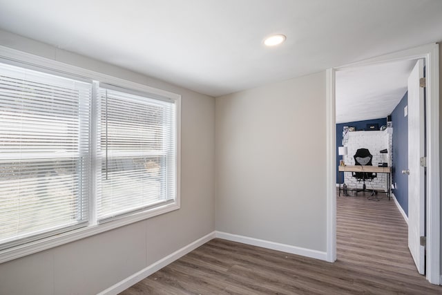 empty room featuring dark wood-type flooring and baseboards