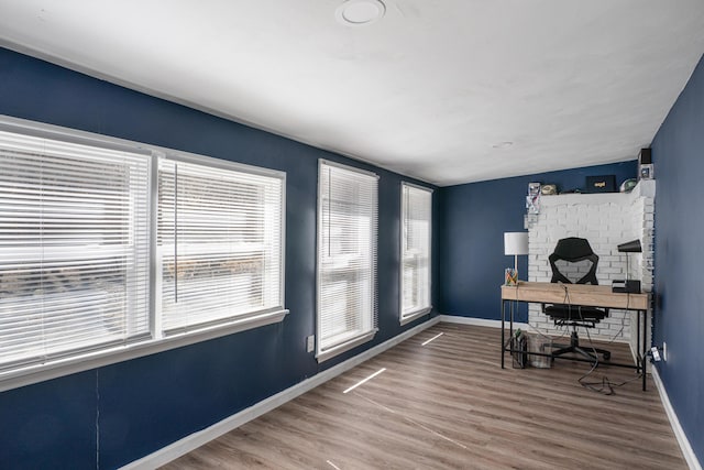 office with baseboards, a wealth of natural light, and wood finished floors