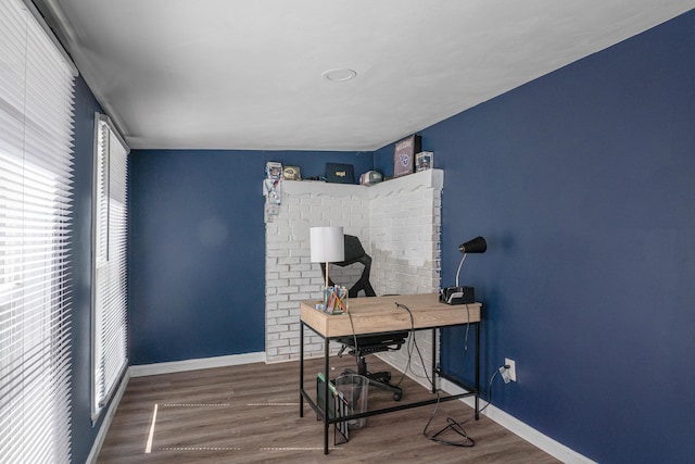 home office with baseboards and wood finished floors