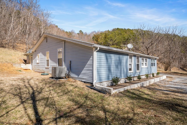 view of property exterior featuring a yard and central AC unit