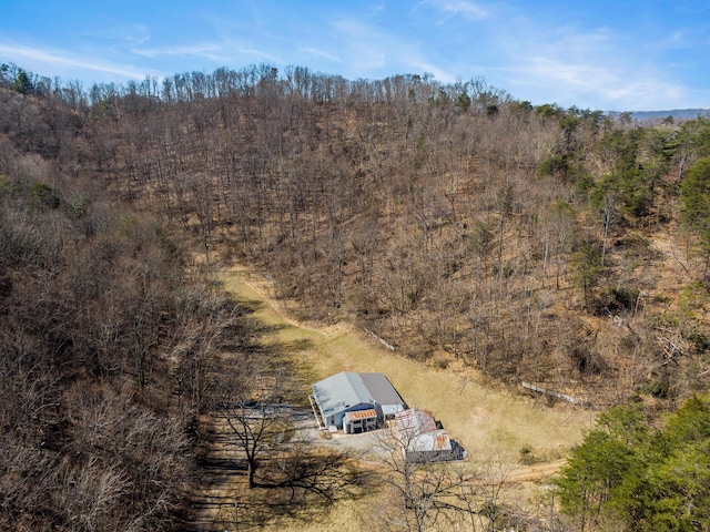 drone / aerial view featuring a view of trees