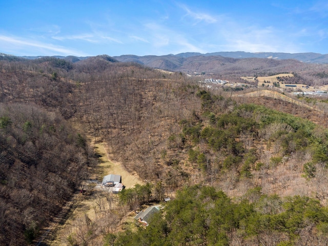 aerial view with a mountain view and a wooded view