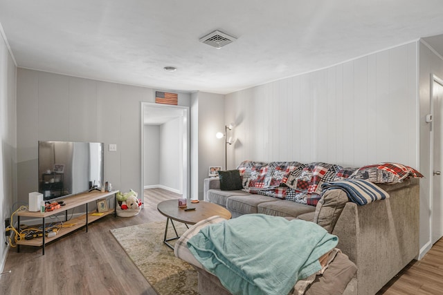 living room with visible vents and wood finished floors