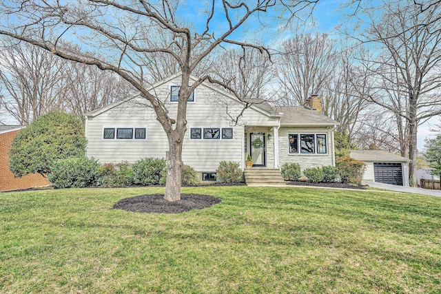 view of front of house with a detached garage, an outbuilding, a chimney, and a front yard